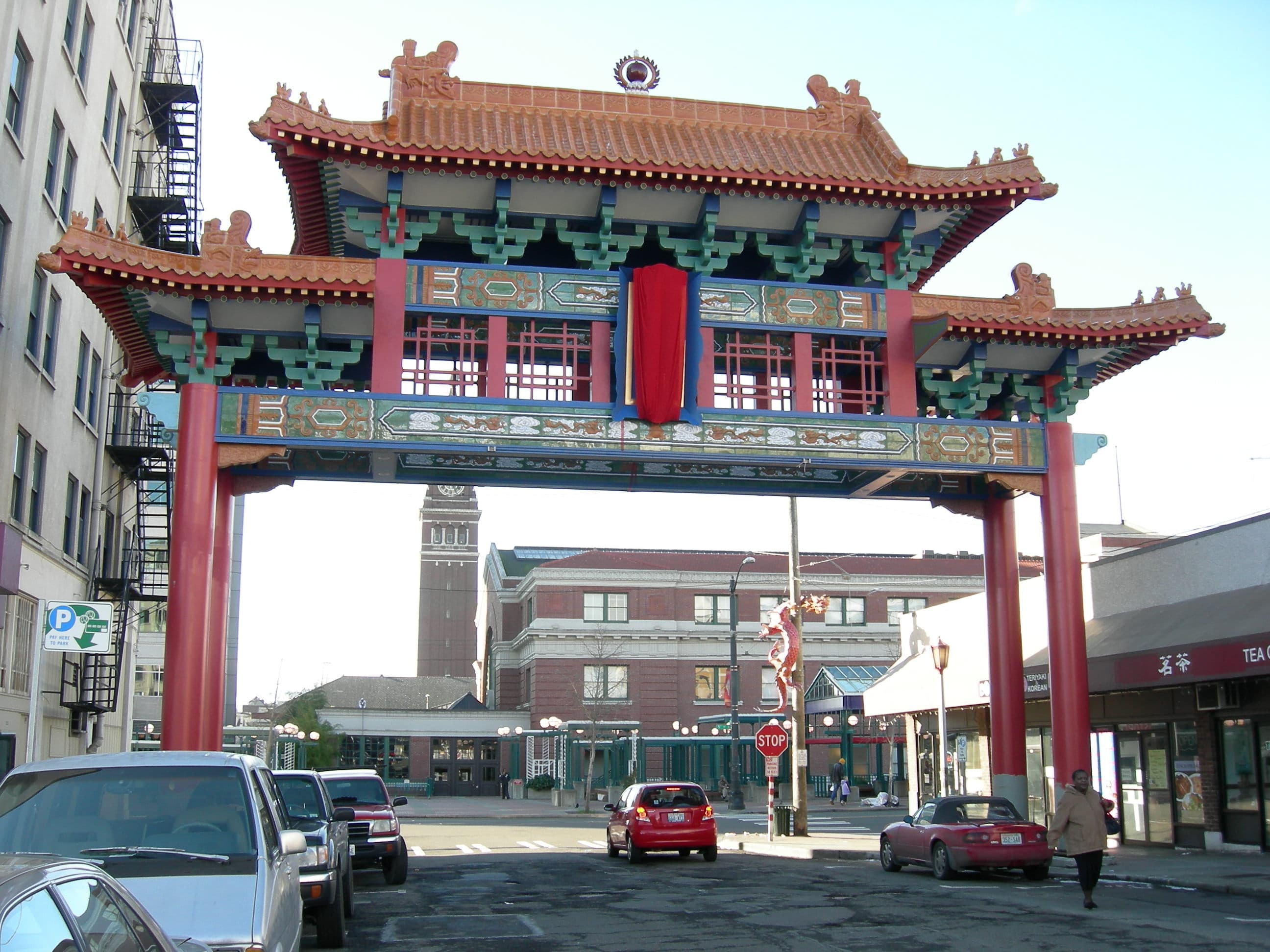 The Historic Chinatown Gate on S King Street, with King Street Station's clock tower in the background