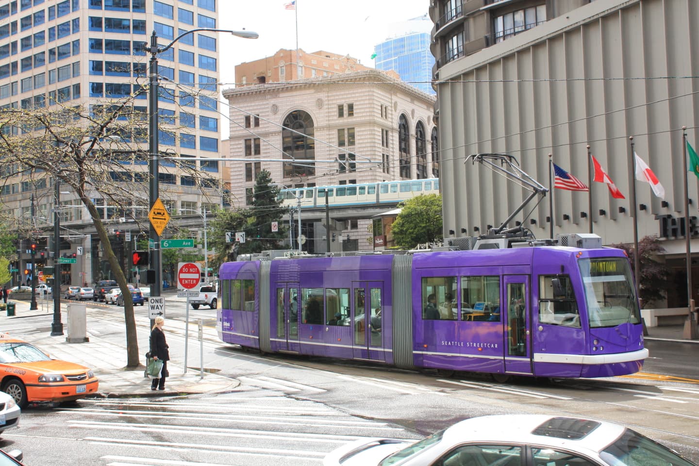 A Seattle Streetcar (the South Lake Union Streetcar) approaching Stewart Street, with the monorail and downtown towers in the background